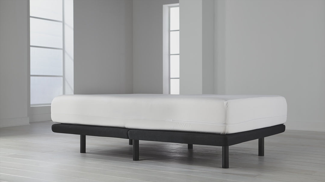 Angled view of OmniGuard Total Encasement Mattress Protector showing full-encasement fit and smooth white fabric